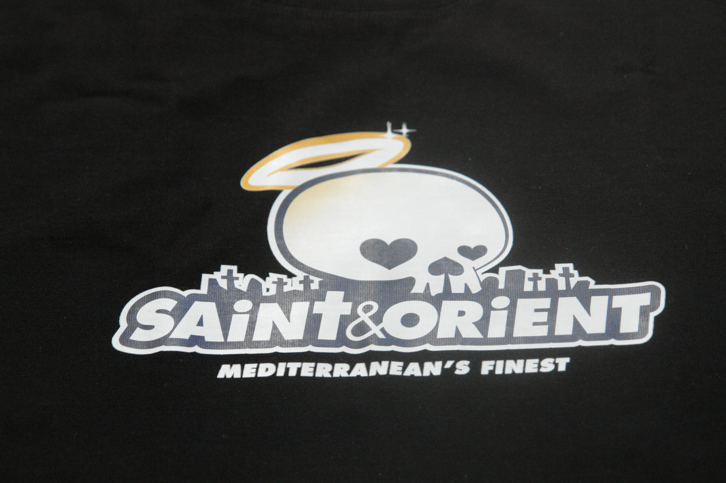 Black t-shirt with playful cartoon skull and graveyard illustration