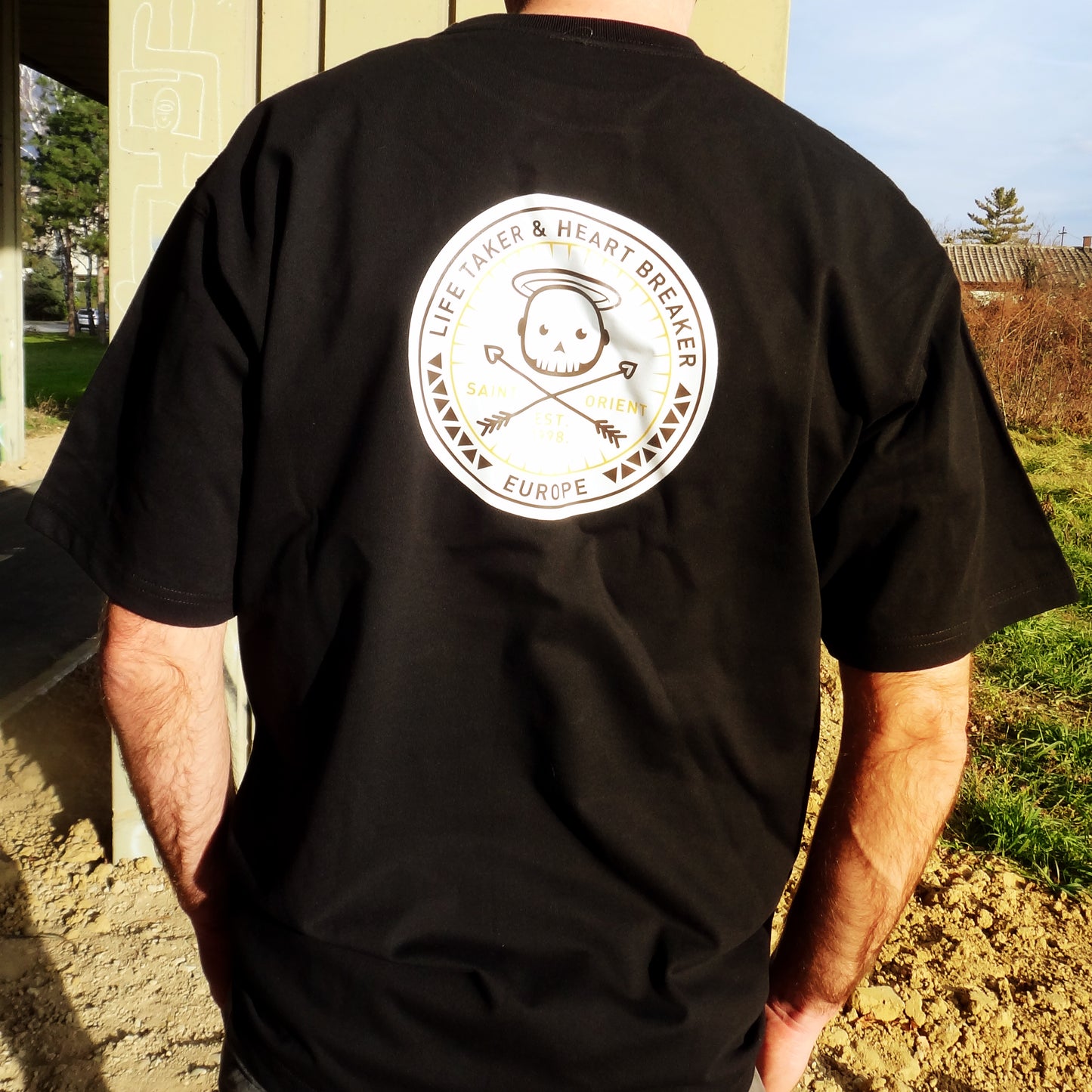 Black oversized t-shirt with Life Taker Heart Breaker circular badge logo