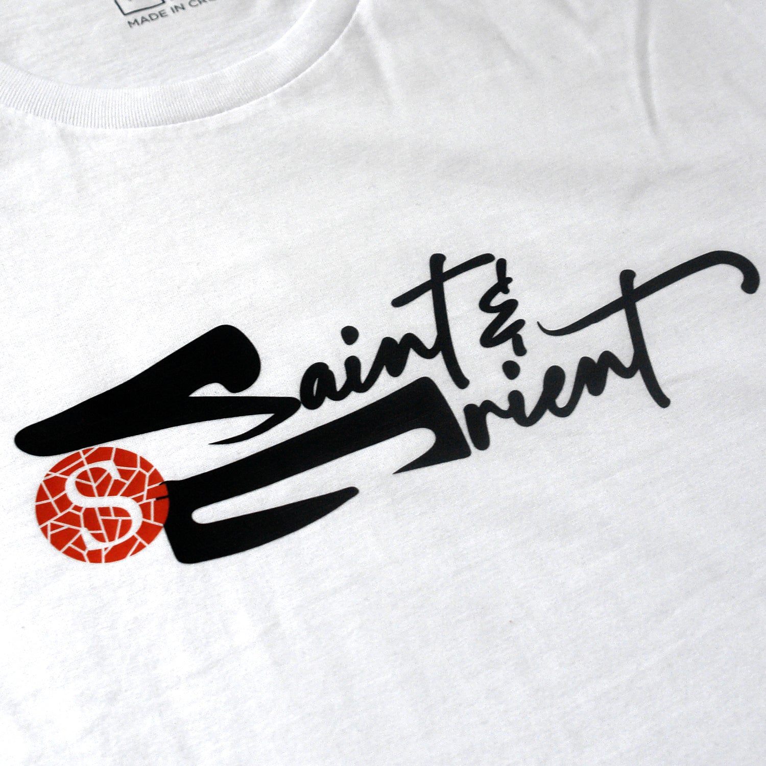 Loose calligraphy graphic on white Saint&Orient tee